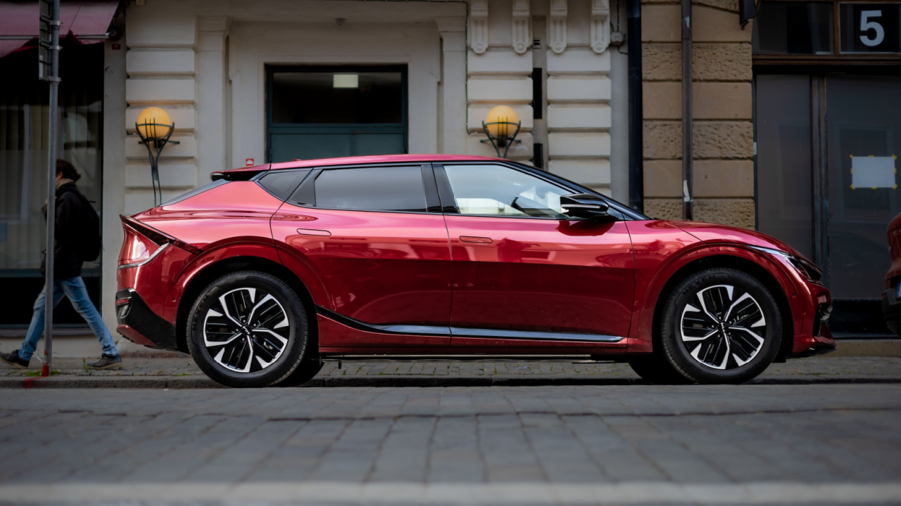 Side view of a red Kia EV6 electric car.