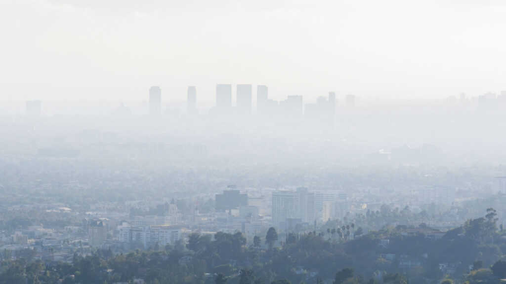 Downtown skyscrapers silhouettes of the city of Los Angeles. Poor visibility, smog, caused by air pollution.