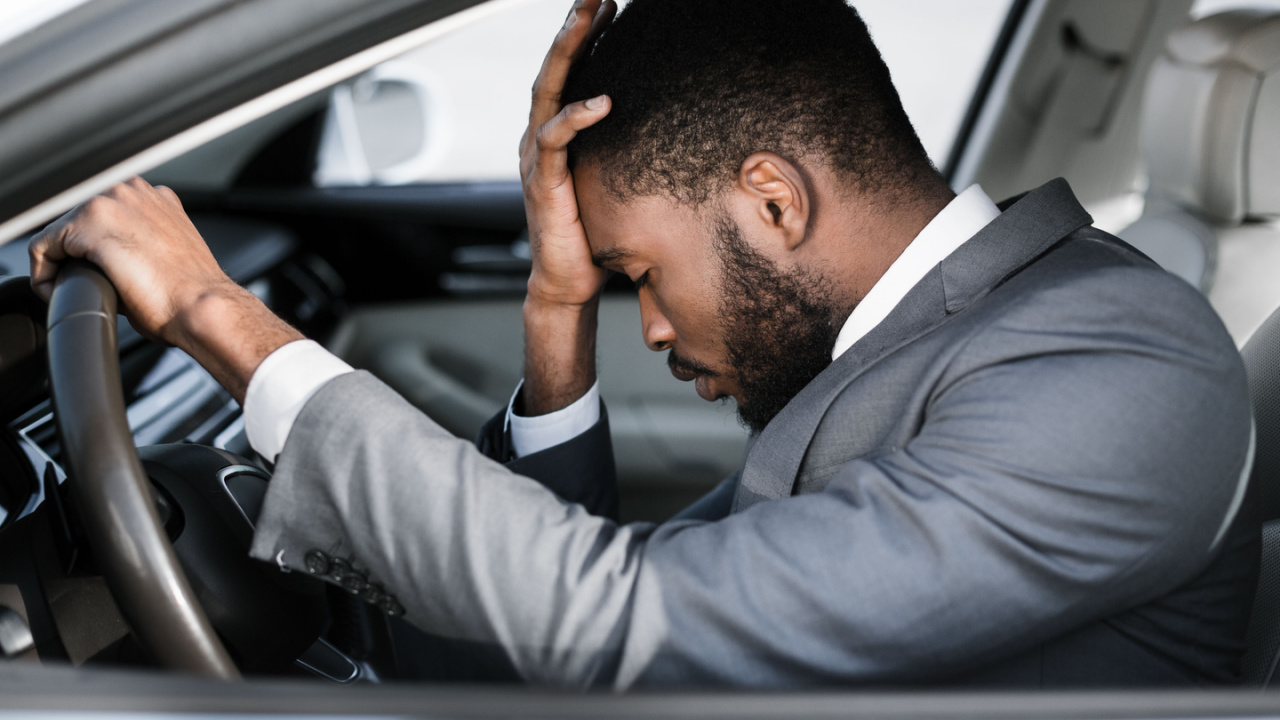 man in car headache