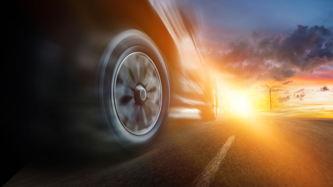 Speeding car with natural energy technology. Low angle side view of car driving fast on motion blur