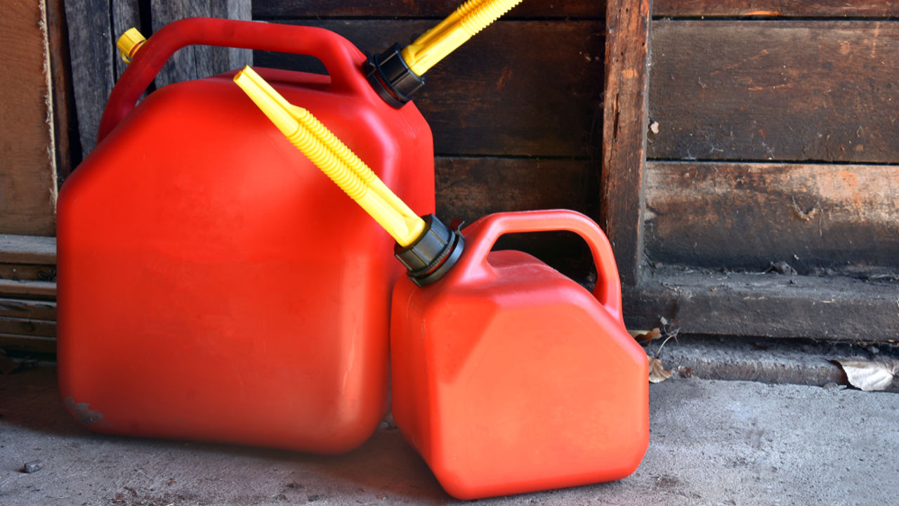 An image of two red plastic gas canisters.