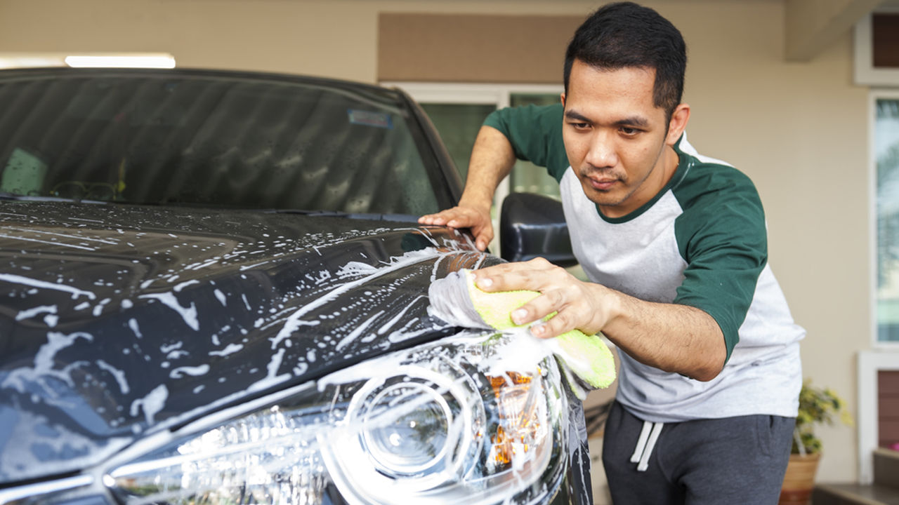 Man worker washing car's on a car wash. Cleaning concept.