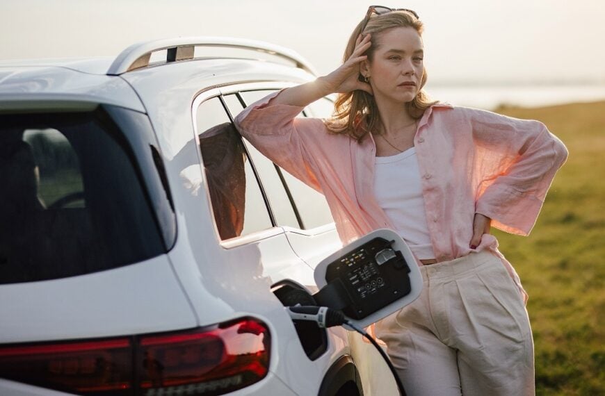 Woman waiting for her electric car to charge