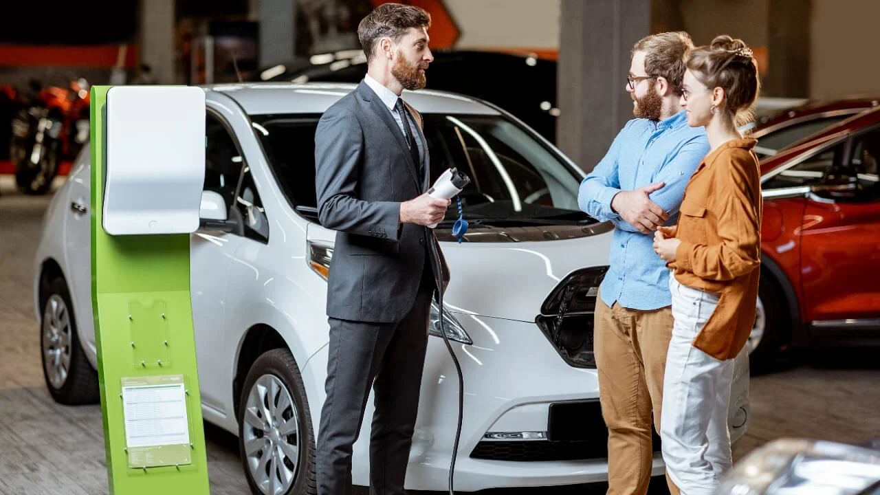 electric vehicle in car dealership, EV vehicle charging station, electric car sales, couple buying car