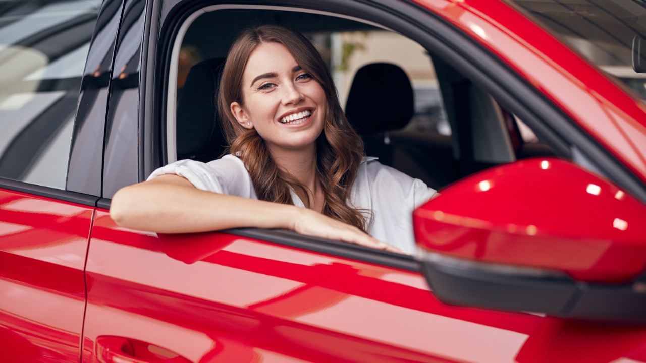 woman smiling while driving