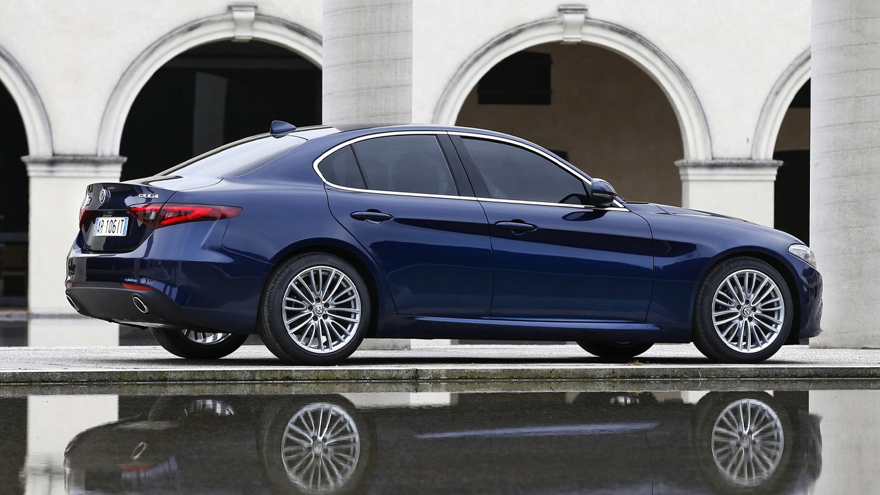 A blue base model Alfa Romeo Giulia, rear 3/4 view