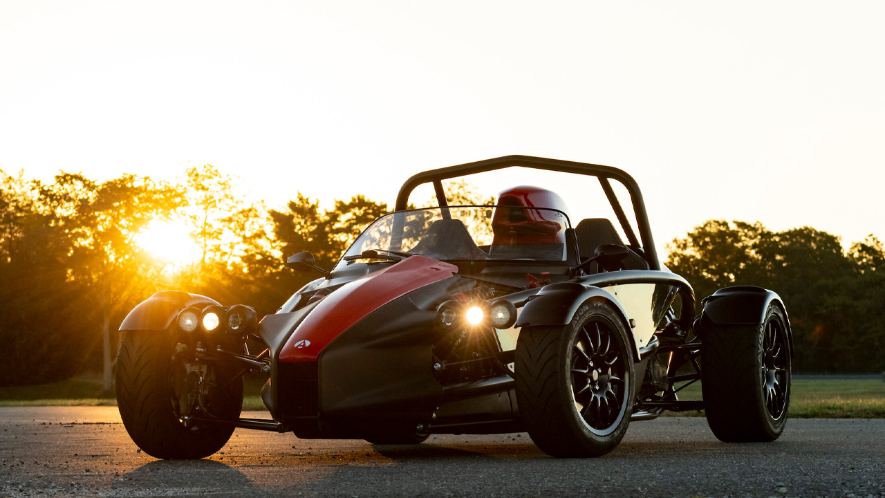 The Ariel Atom 4 with red accents at sunrise, front 3/4 view