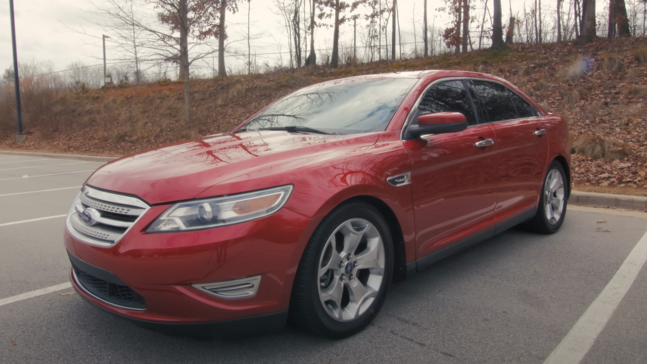 A red Ford Taurus SHO on a parking lot, front 3/4 view