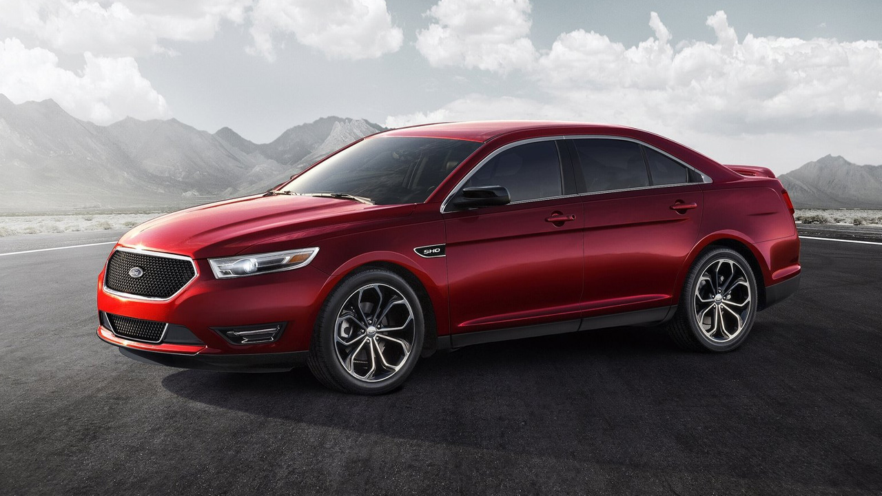 A facelift Ford Taurus SHO in red, front 3/4 view