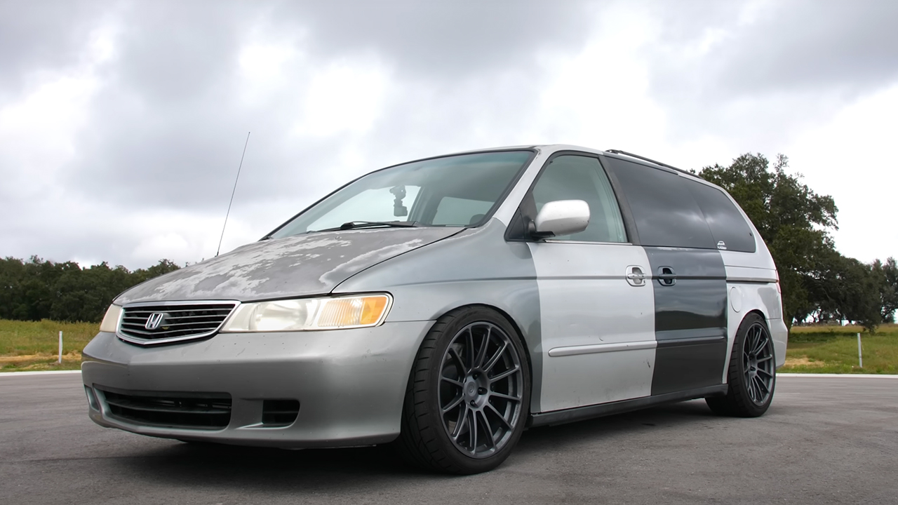 A sleeper Honda Odyssey with mismatched body panels, front 3/4 view