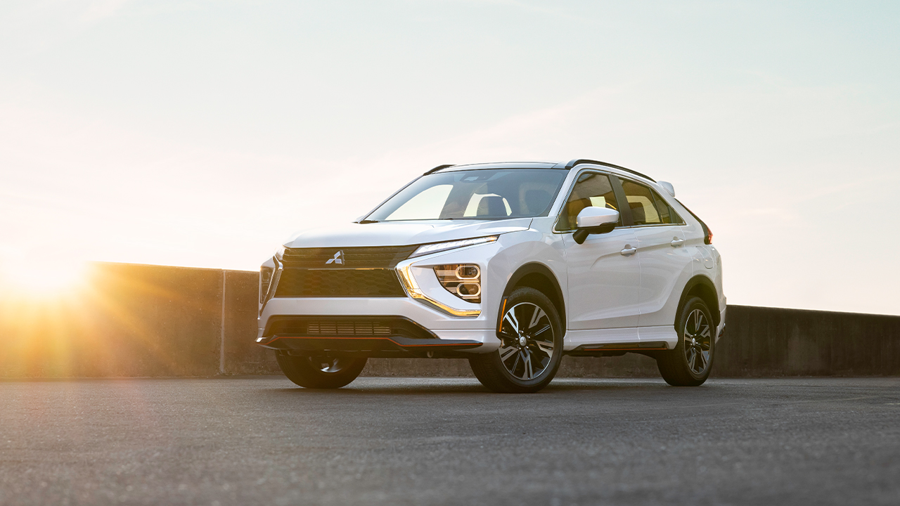 A Mitsubishi Eclipse Cross in white at sunrise, front 3/4 view