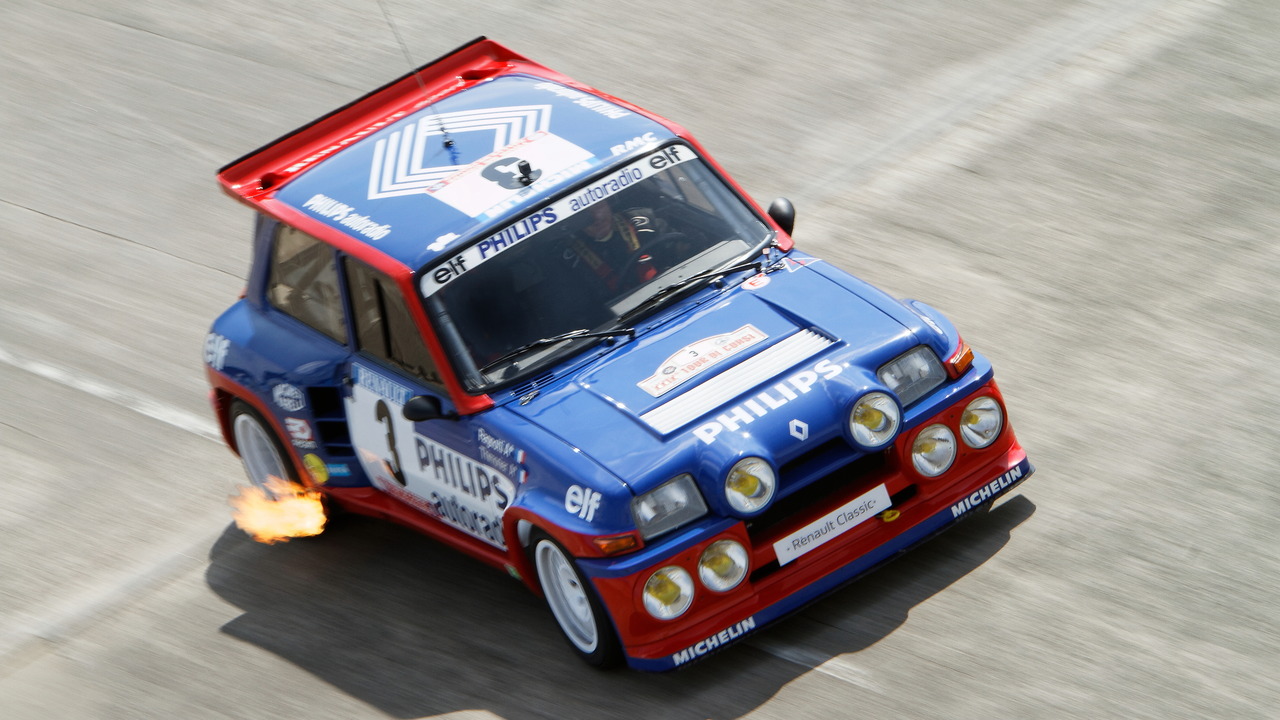 Blue and Red Classic Renault 5 Turbo Race Car Driving Down Track Spitting Flame