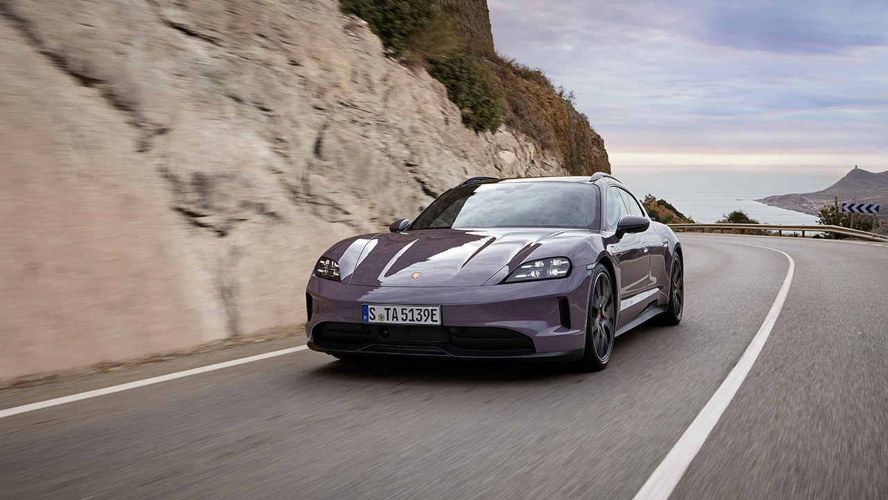 A Porsche Taycan in purple on the move