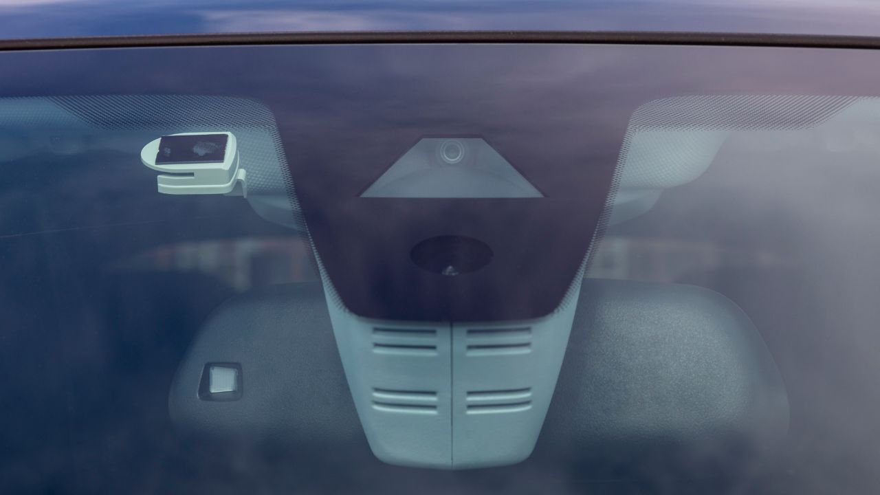 modern car safety feature, cameras and sensors to improve driving safety integrated into the car's windshield.