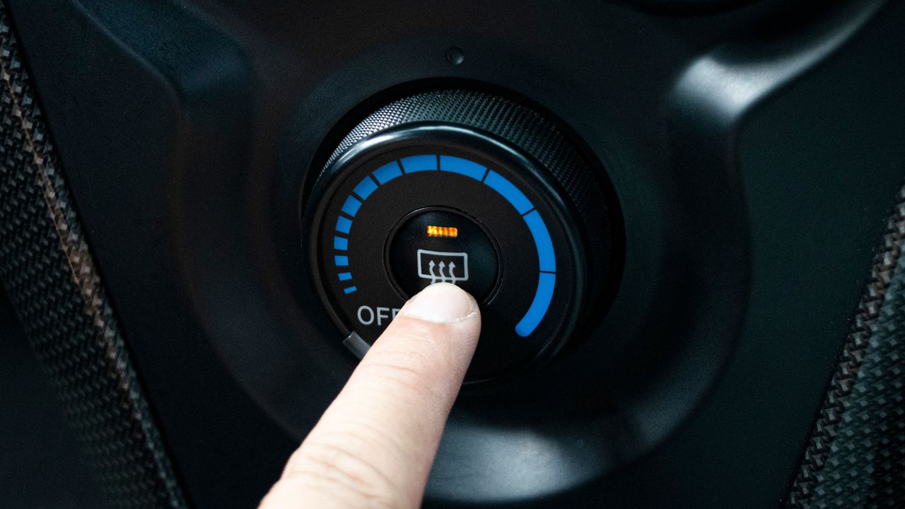 Finger pressing car defrost button