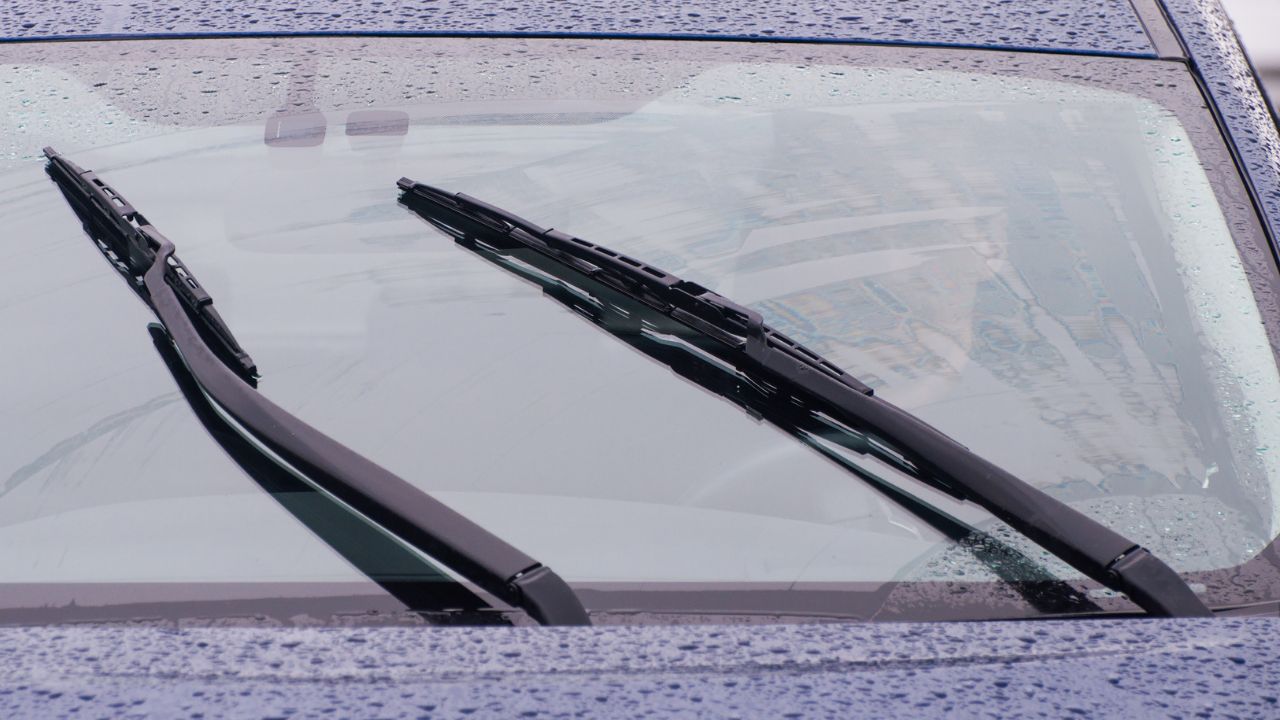 view of the car windshield wipers in the rain