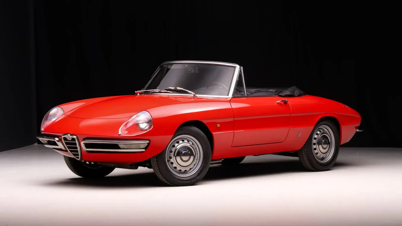 Red 1967 Alfa Romeo Spider Duetto Parked With Roof Dow Front 3/4 View