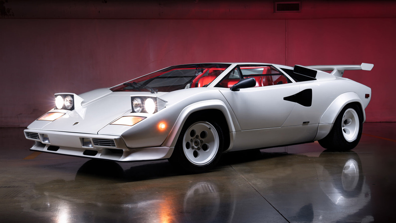 White 1984 Lamborghini Countach 5000S With Red Interior With Its Pop Up Lights Open Front 3/4 View