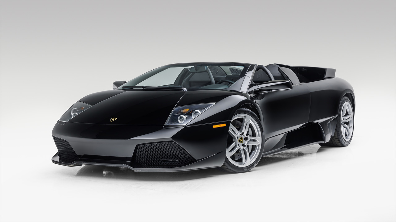 Black 2008 Lamborghini Murcielago LP640 Roadster Parked With Roof Down In Studio With Flaps Open Front 3/4 View