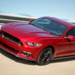 Red 2016 Ford Mustang driving.