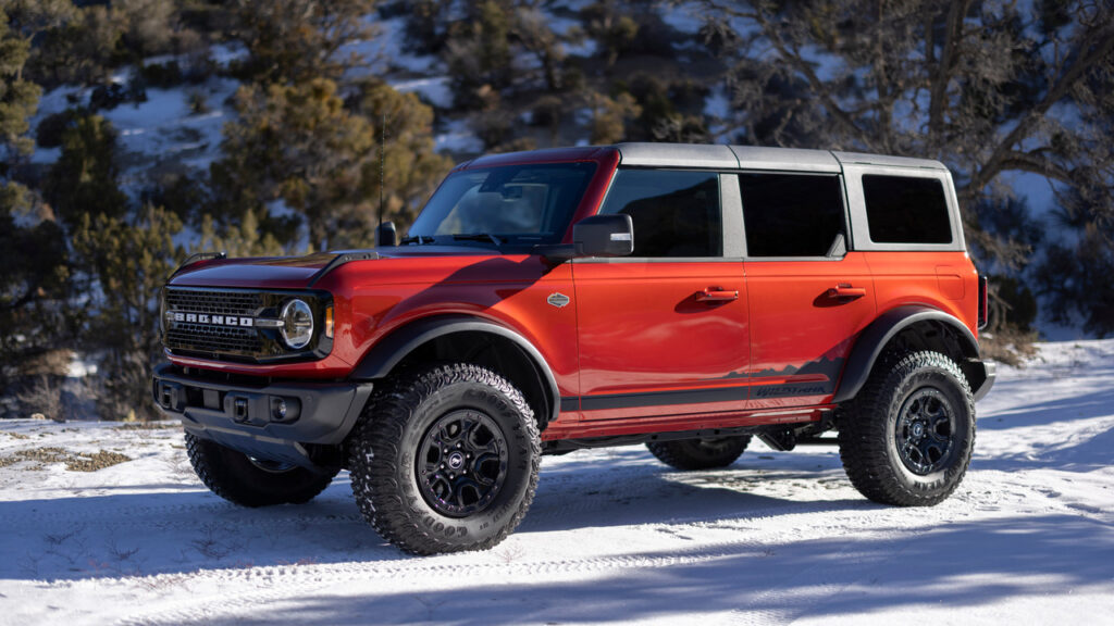 Orange 2022 Ford Bronco Wildtrack Parked In The Snow Front 3/4 View