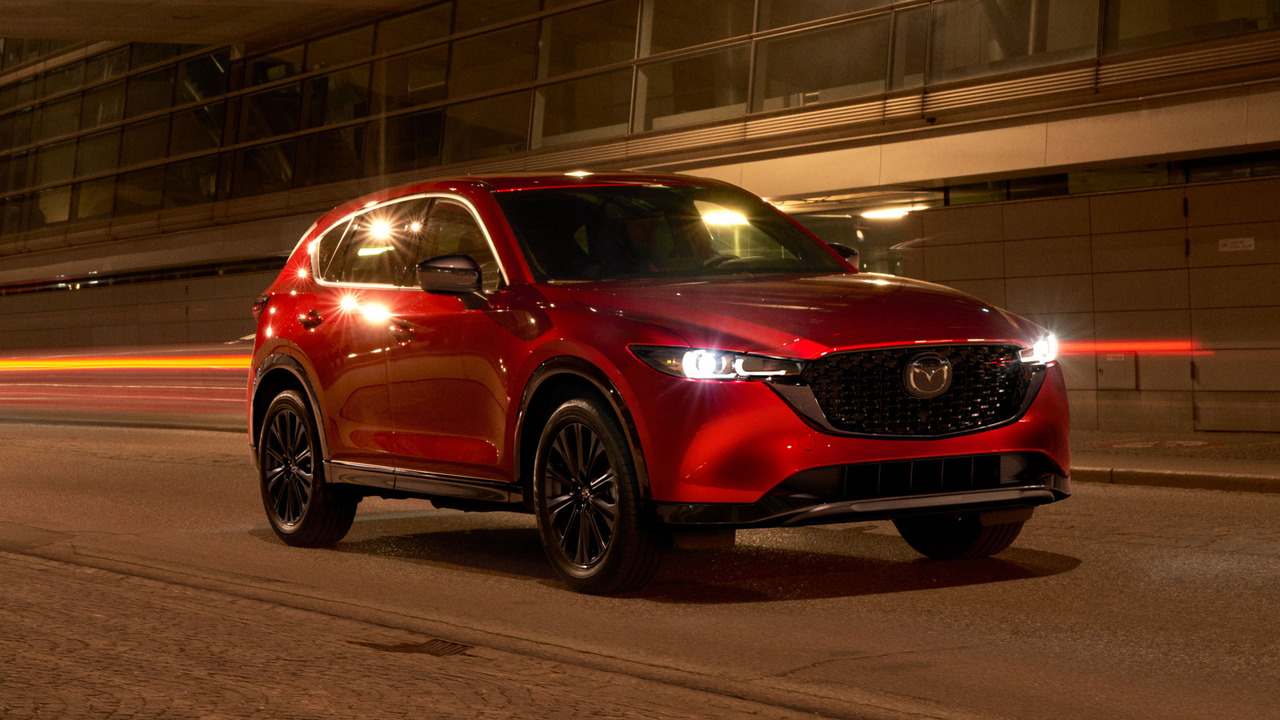 Red 2022 Mazda CX-5 Parked At Night With Lights On Front 3/4 View