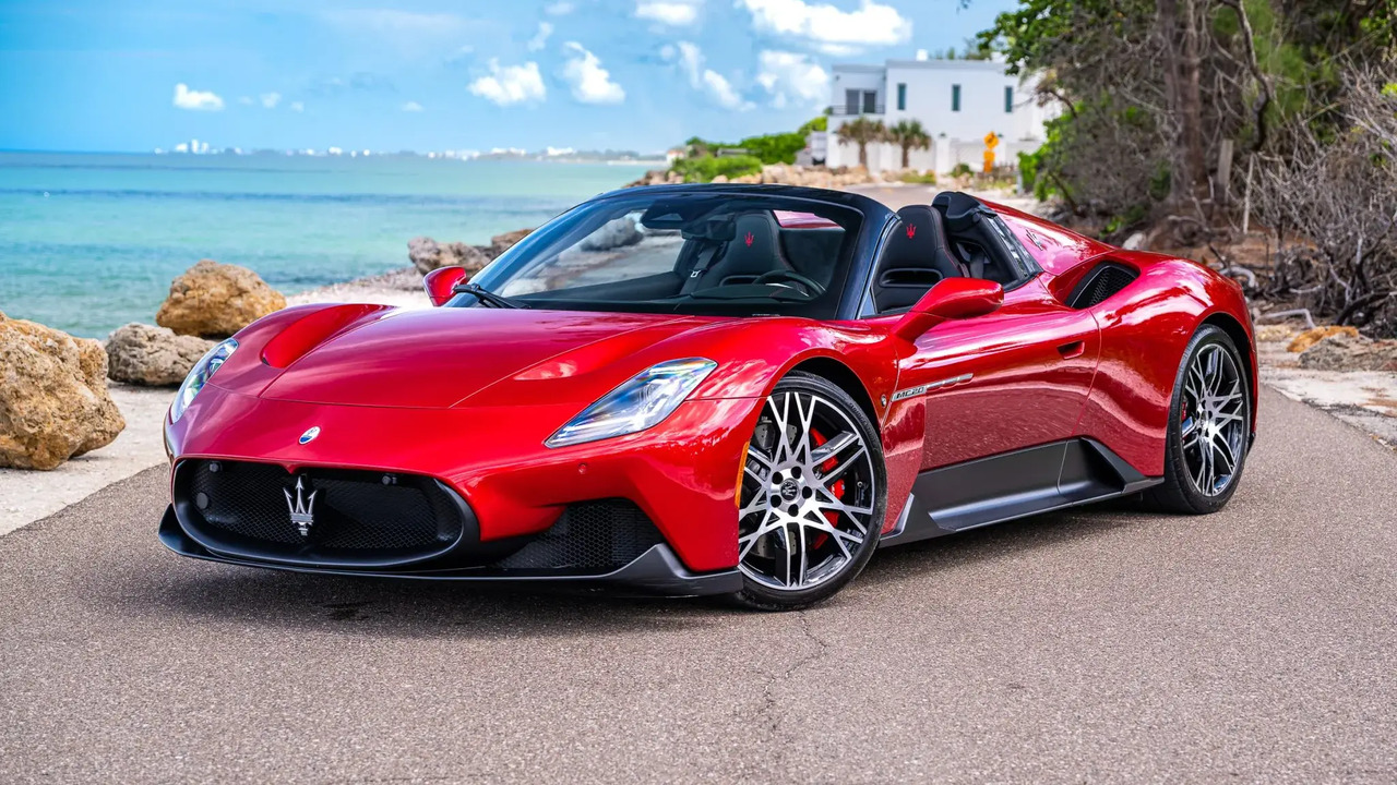 Red 2023 Maserati MC20 Cielo Parked By Sea With Roof Down Front 3/4 View