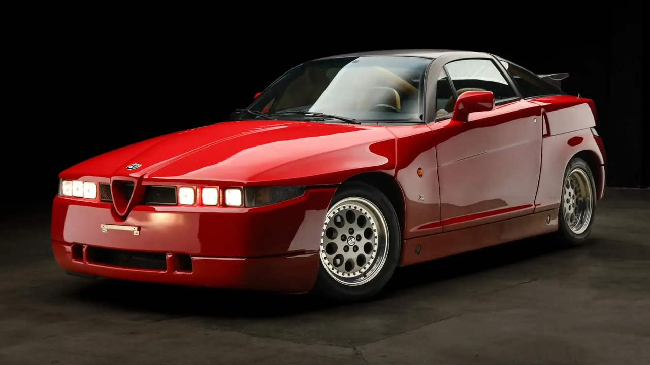 Red 1991 Alfa Romeo SZ With Black Roof Parked In Studio With Lights On Front 3/4 View