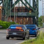 An undercover unmarked police OPP vehicle with flashing red and blue lights has pulled over a car on the side of the road