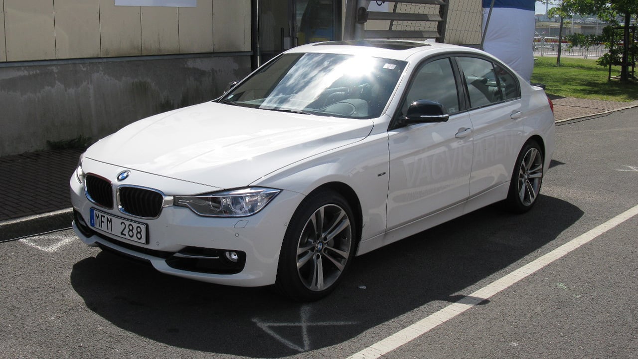 A white F30 BMW 335i without the M Sport kit, front 3/4 view