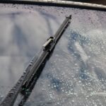 Car wipers wipe raindrops from car windows