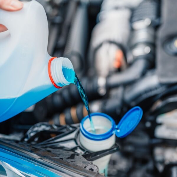 Filling a windshield washer tank with an antifreeze in winter cold weather
