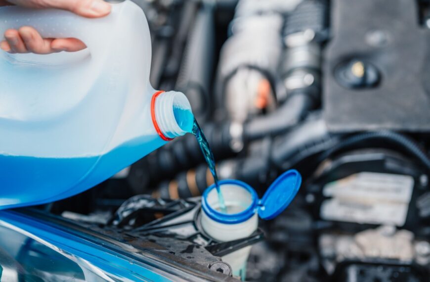 Filling a windshield washer tank with an antifreeze in winter cold weather