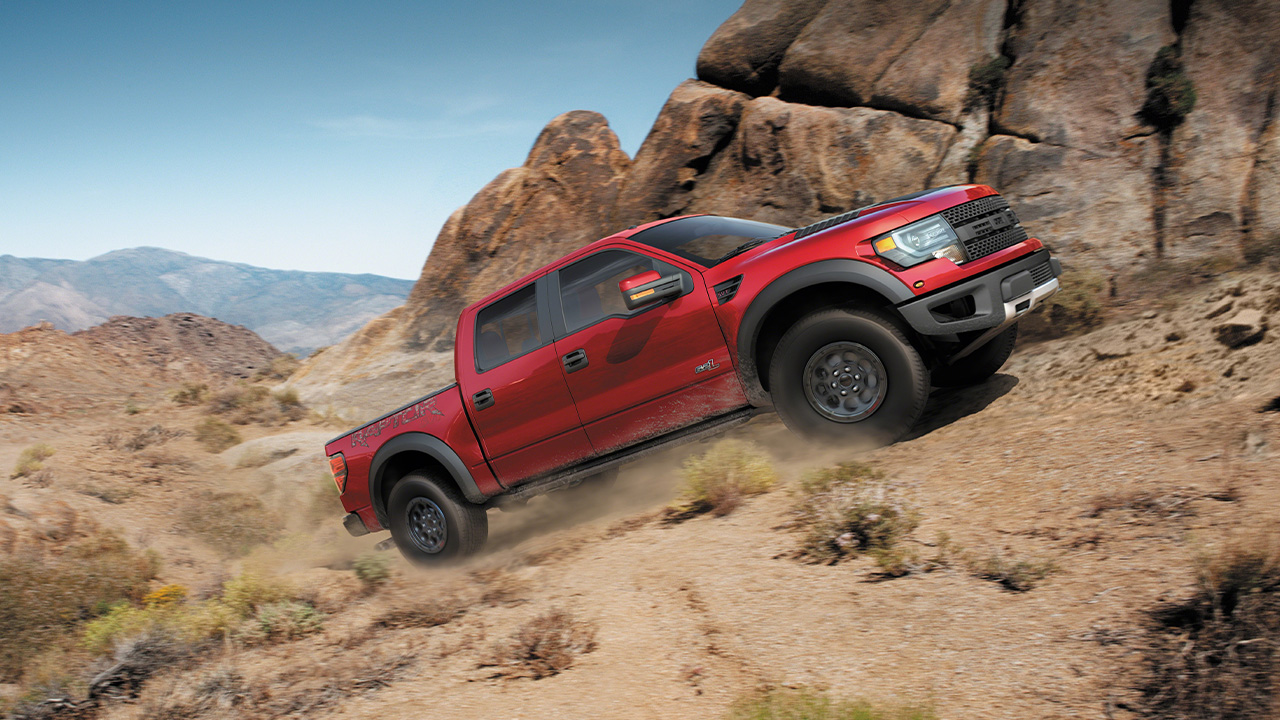 A first generation Ford F-150 SVT Raptor offroading, front 3/4 view