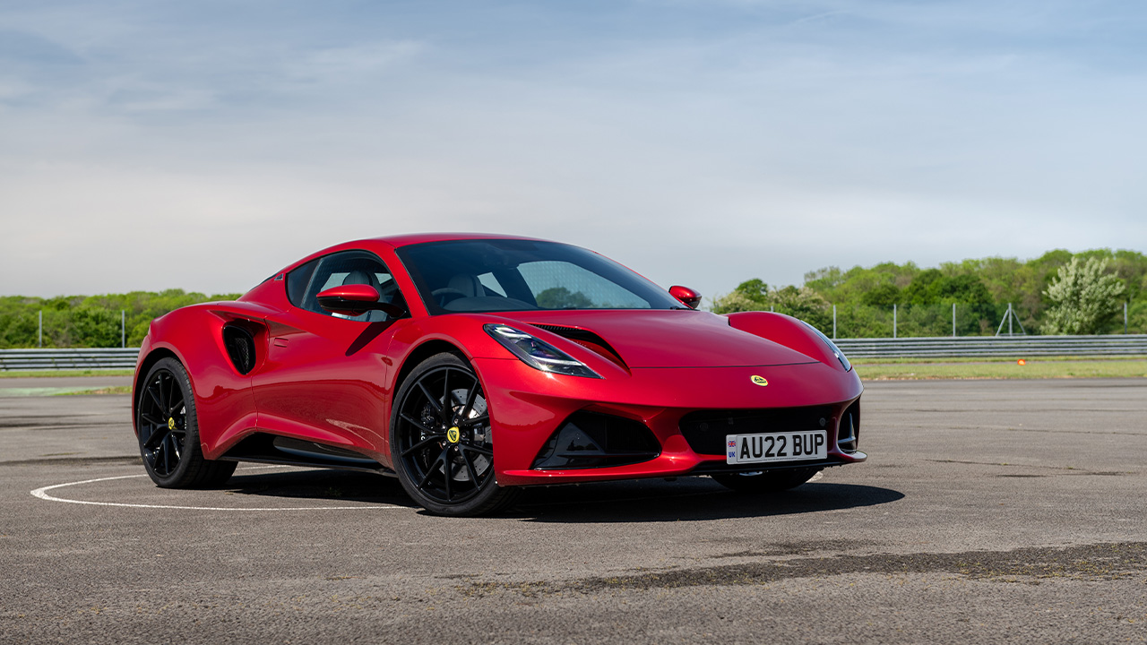 The Lotus Emira in red with black wheels, front 3/4 view