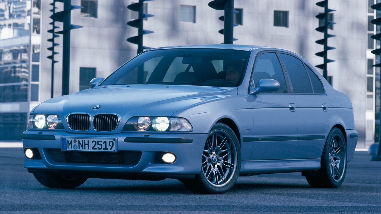 Silver 2009 BMW E39 M5 Sedan Parked With Lights On Front 3/4 View