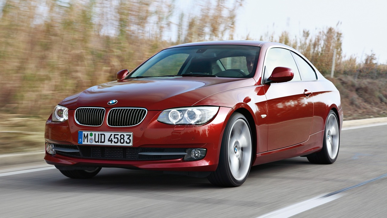 Red 2011 BMW E92 335i Coupe On The Move Front 3/4 View