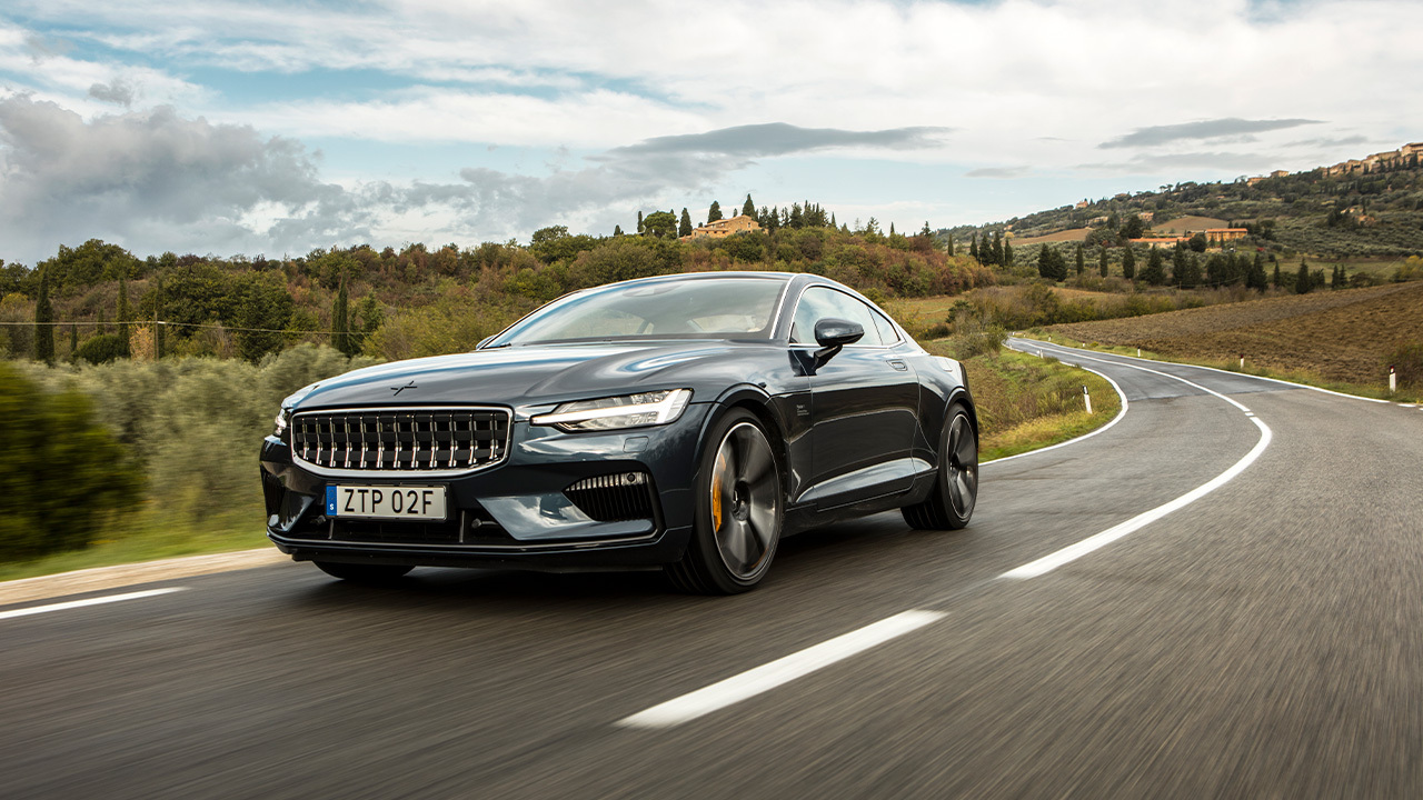 The Polestar 1 on the move, dark gray exterior, front 3/4 view