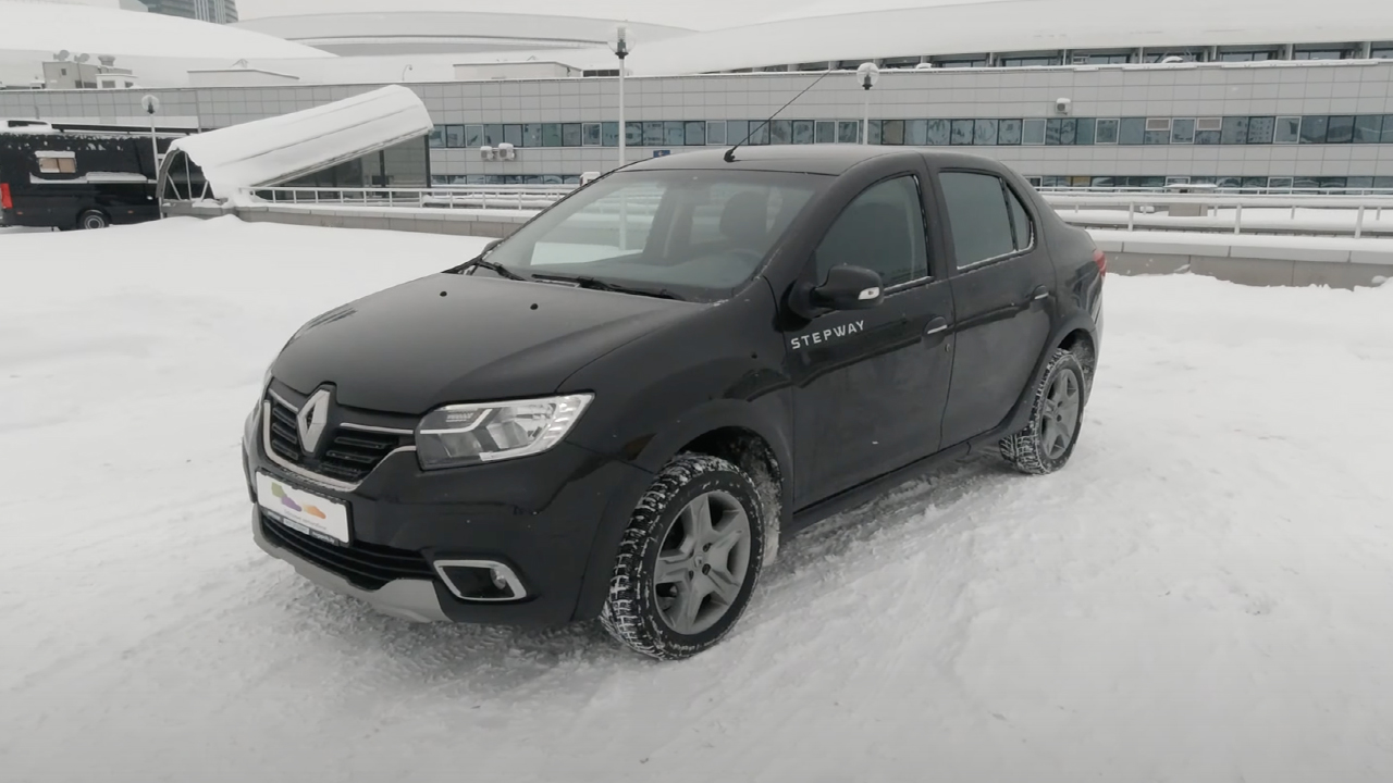 A Renault Logan Stepway in the snow, black exterior, front 3/4 view