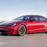 Red 2021 Tesla Model S Plaid Driving On The Road Front 3/4 View