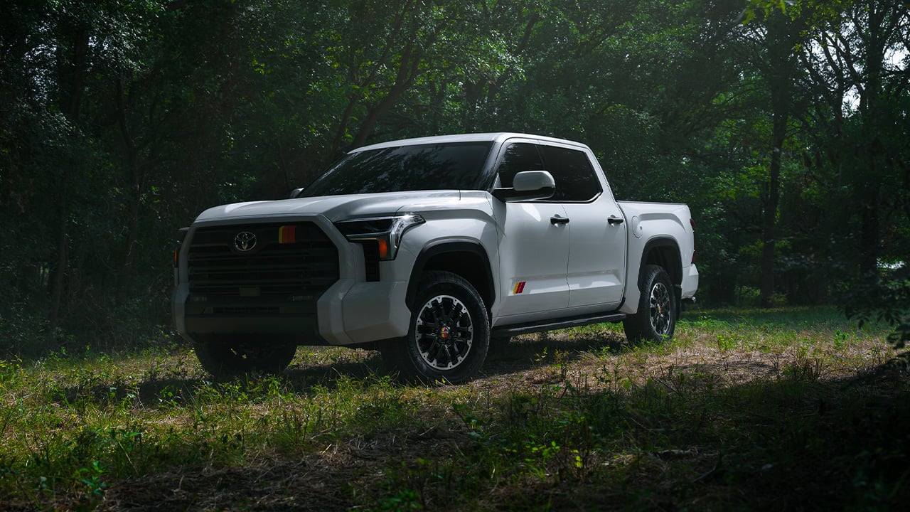 A white Toyota Tundra with the new TRD Rally package, front 3/4 view, forest