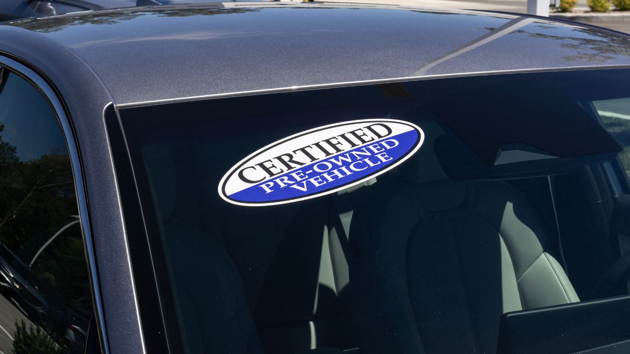 Certified Pre-Owned vehicle sign on a used car. With high price concerns, used and pre-owned vehicles are in high demand.