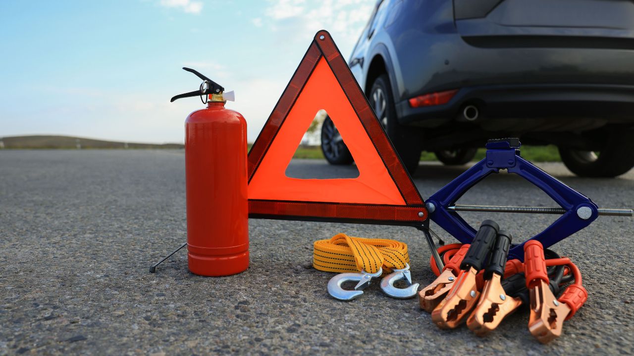 Emergency warning triangle and car safety equipment outdoors