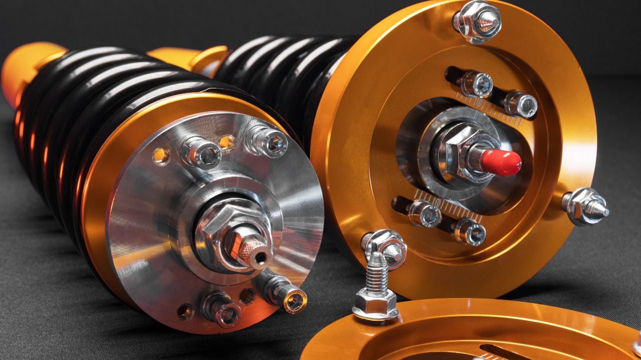 suspension tuning, coilovers, shock absorbers and front springs in yellow and gold colors for a sports drift car on a dark background