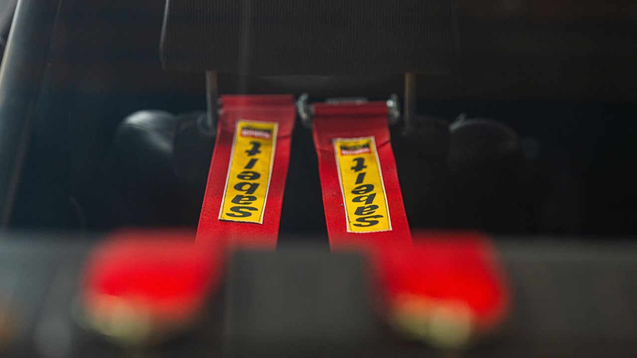 Red Seatbelt racing harness in a rally car