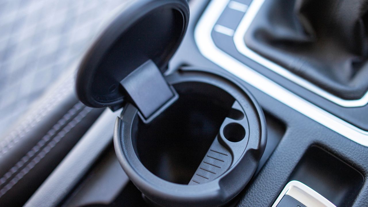 Portable trash can and ashtray in a car