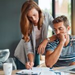 A young couple looking over a budget.