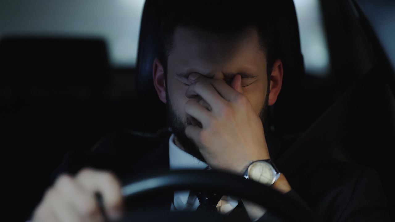 man tired and frustrated behind wheel
