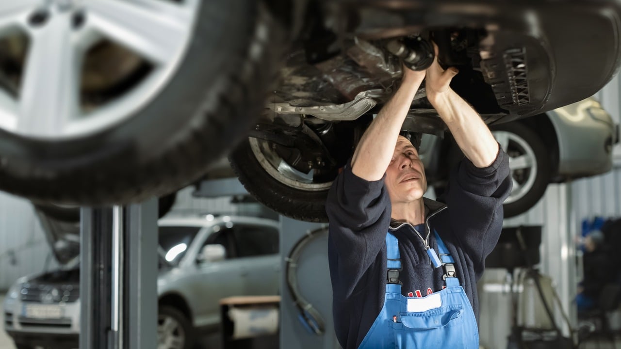 Mechanic performing an oil change.