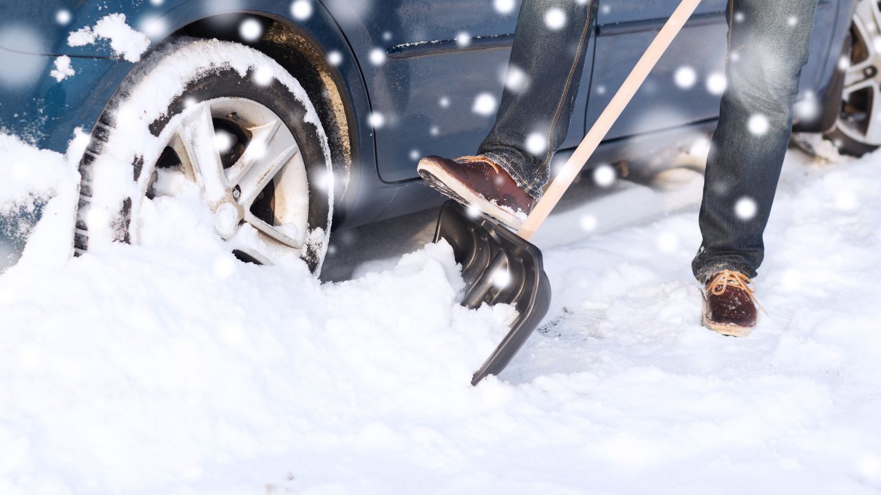shoveling out car from snow